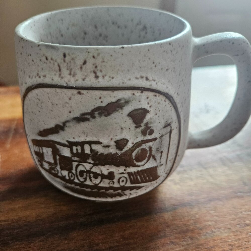 vintage onion river speckled mug with raised locomotive emblem,